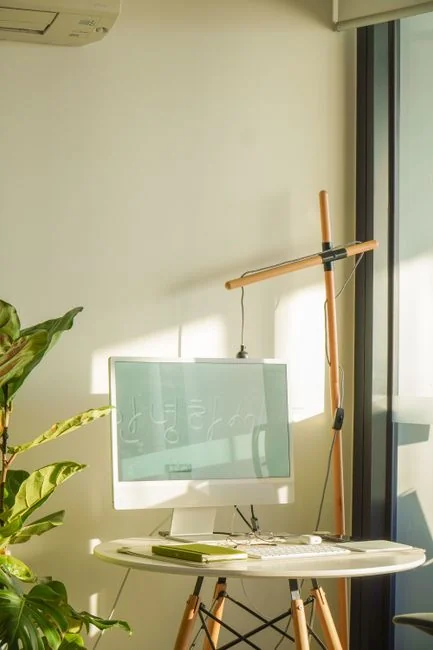 A modern workspace with a smartphone displaying a screen and a computer setup, ideal for business and technology themes.